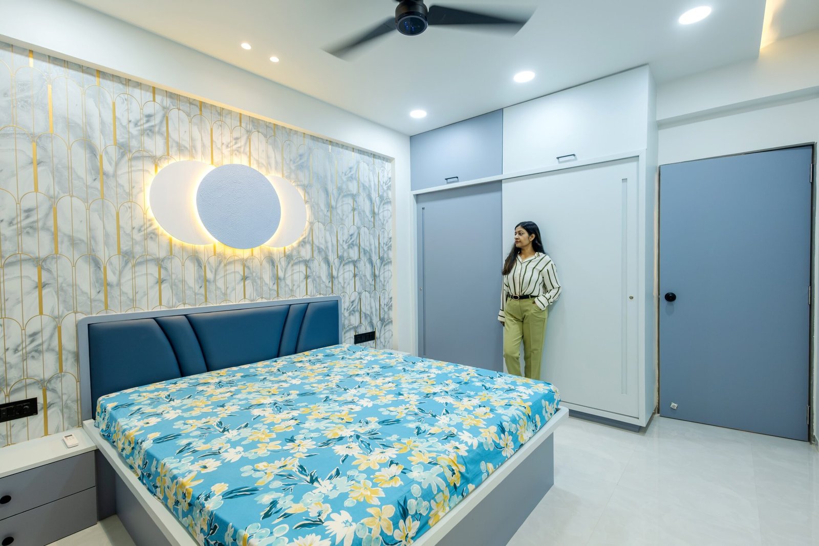 Blue bedroom with coordinated headboard and overhead storage
